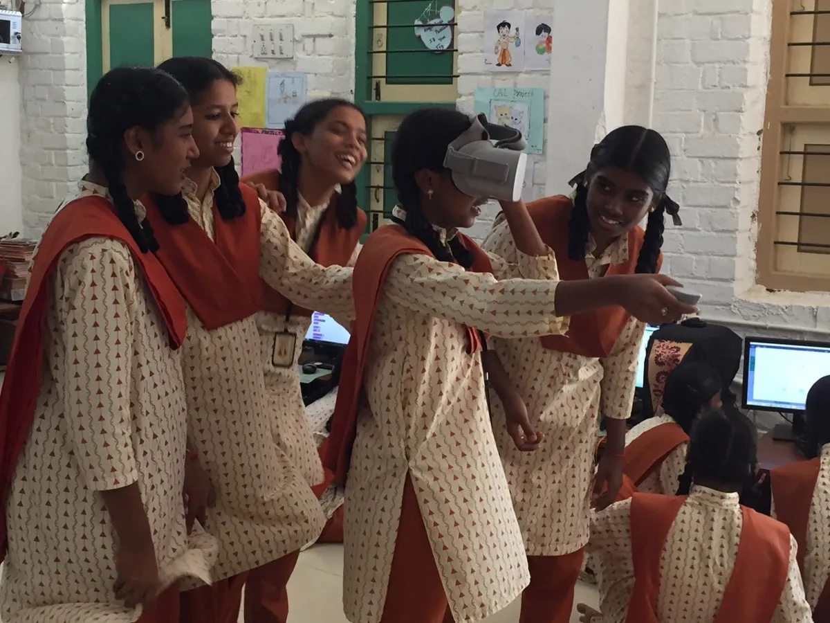 Students working together at computers in a school lab